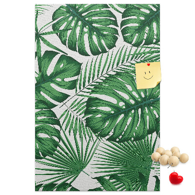 Bacheca di sughero con stampa di foglie di Monstera su sfondo chiaro