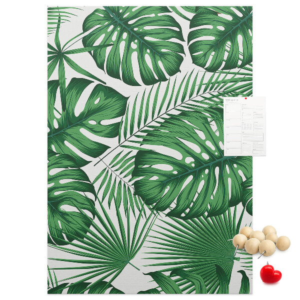 Bacheca di sughero con stampa di foglie di Monstera su sfondo chiaro