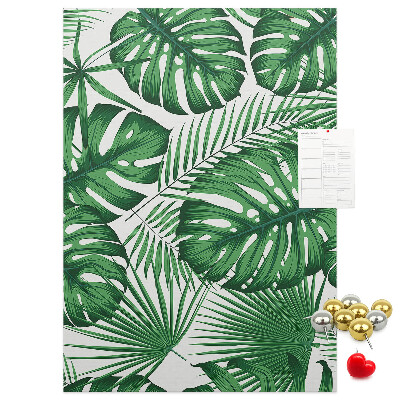 Bacheca di sughero con stampa di foglie di Monstera su sfondo chiaro