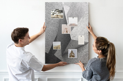 Bacheca di sughero con geometrie concrete in diverse tonalità di grigio