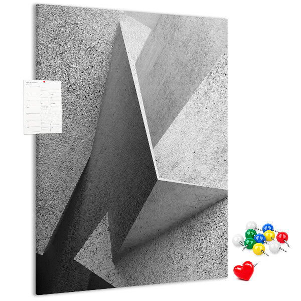 Bacheca di sughero con geometrie concrete in diverse tonalità di grigio