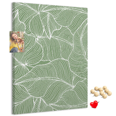 Bacheca di sughero con stampa di foglie delicate su sfondo verde