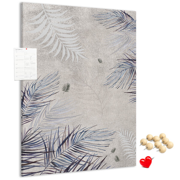 Bacheca di sughero con stampa di foglie delicate su sfondo grigio