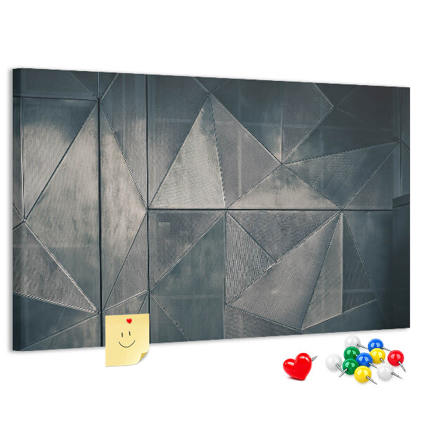 Lavagna di sughero con forme geometriche in diverse tonalità di grigio