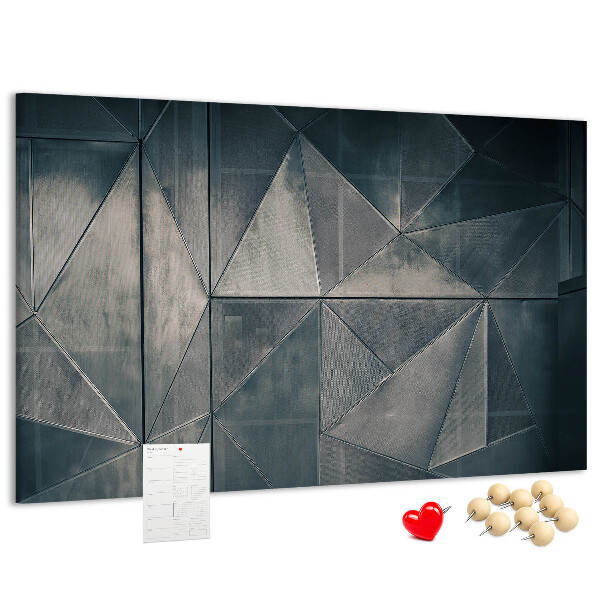 Lavagna di sughero con forme geometriche in diverse tonalità di grigio