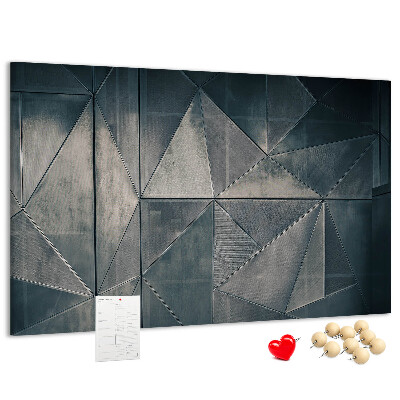 Lavagna di sughero con forme geometriche in diverse tonalità di grigio