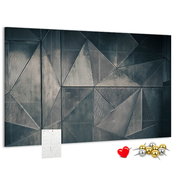 Lavagna di sughero con forme geometriche in diverse tonalità di grigio