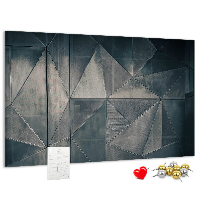 Lavagna di sughero con forme geometriche in diverse tonalità di grigio