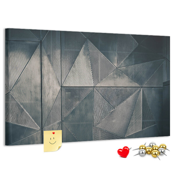 Lavagna di sughero con forme geometriche in diverse tonalità di grigio