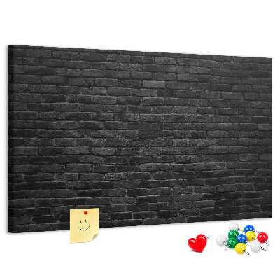 Lavagna di sughero con texture di muro in mattoni scuri dalla superficie ruvida