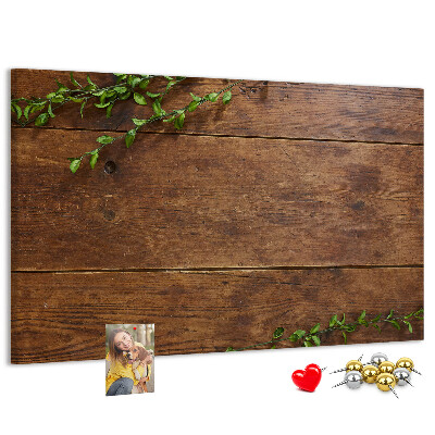 Lavagna di sughero con cornice in legno naturale e rami verdi