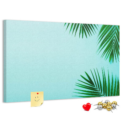 Lavagna di sughero con stampa di foglie tropicali su sfondo blu