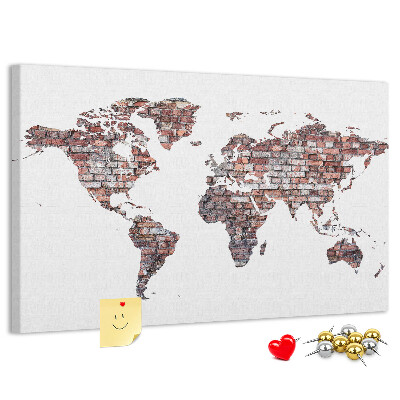 Bacheca in sughero con stampa del mondo su sfondo di muro di mattoni