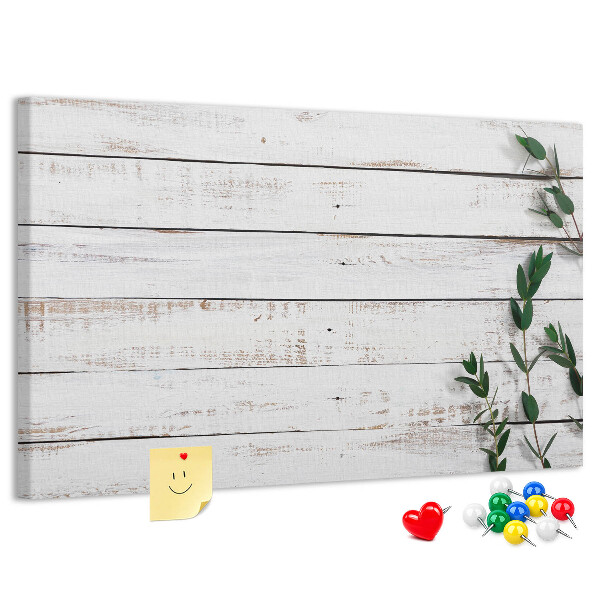 Bacheca in sughero con cornice in legno rustico e rami verdi