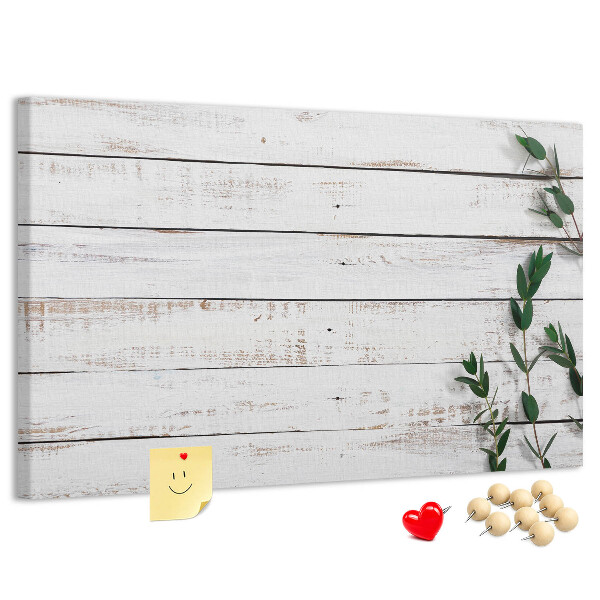 Bacheca in sughero con cornice in legno rustico e rami verdi