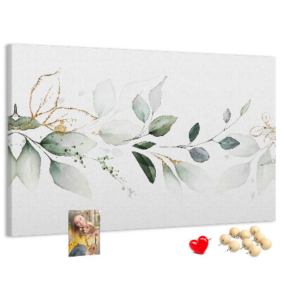 Bacheca in sughero con foglie delicate e dettagli dorati