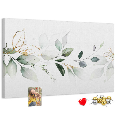 Bacheca in sughero con foglie delicate e dettagli dorati