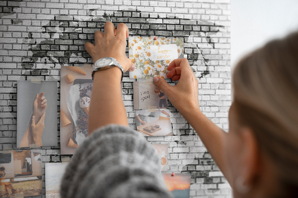 Bacheca in sughero con stampa di una mappa del mondo su muro di mattoni