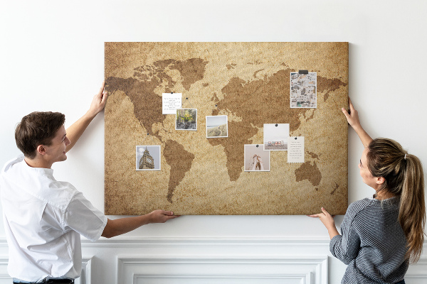 Lavagna di sughero con stampa antica mappa del mondo su sfondo bronzo