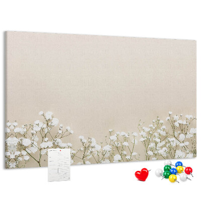 Lavagna di sughero con fiori delicati su sfondo neutro