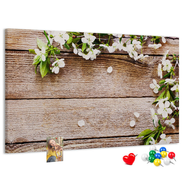 Bacheca in sughero con stampa di fiori su sfondo di tavola in legno